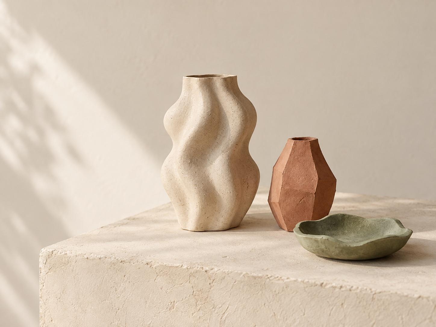 Handmade clay vessels in warm studio light